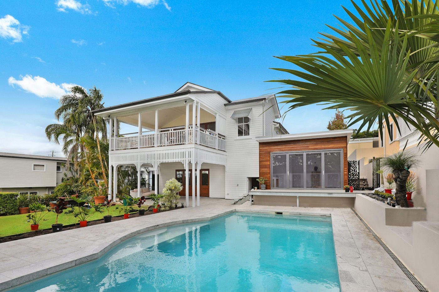 Two-storey white Queenslander with a new coat of paint